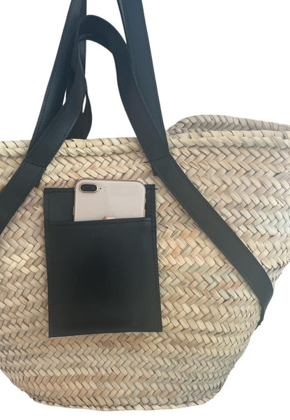 Handmade and woven bag in palm leaves with handles and shoulder strap in black leather